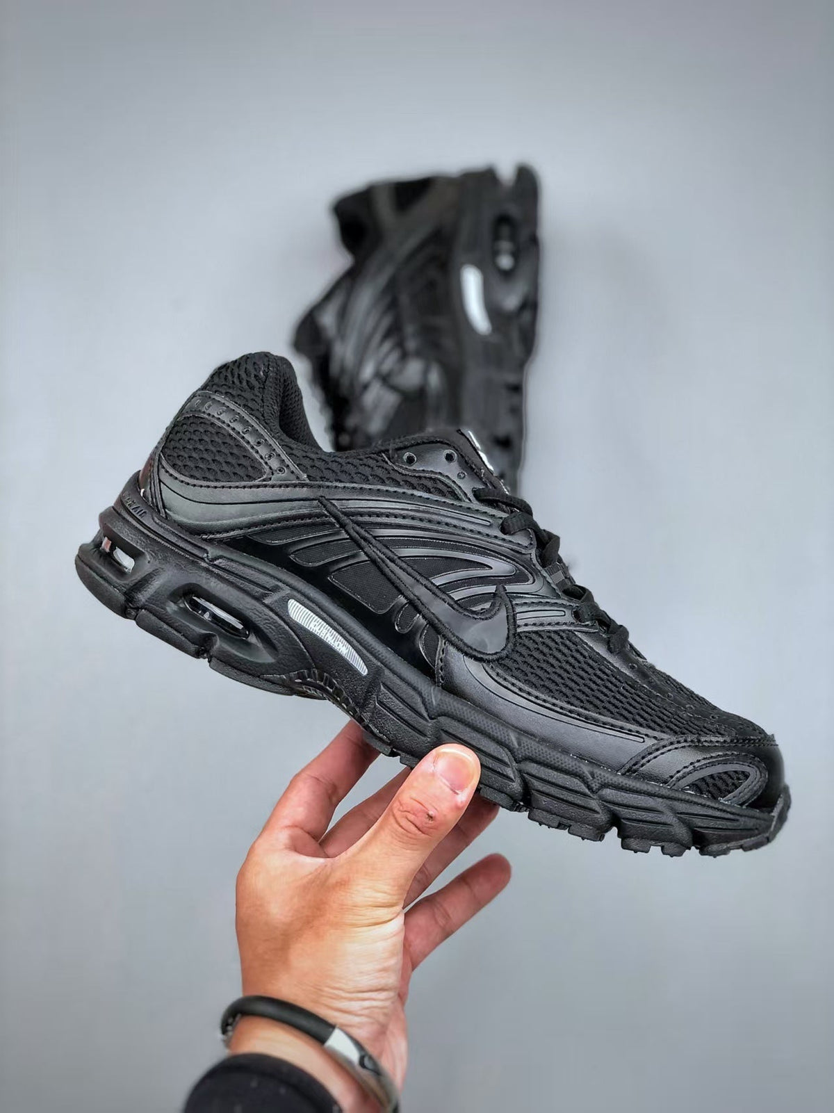 Nike Air Max Moto 2K Low-Top Running Shoes in Black - product image from the listing.