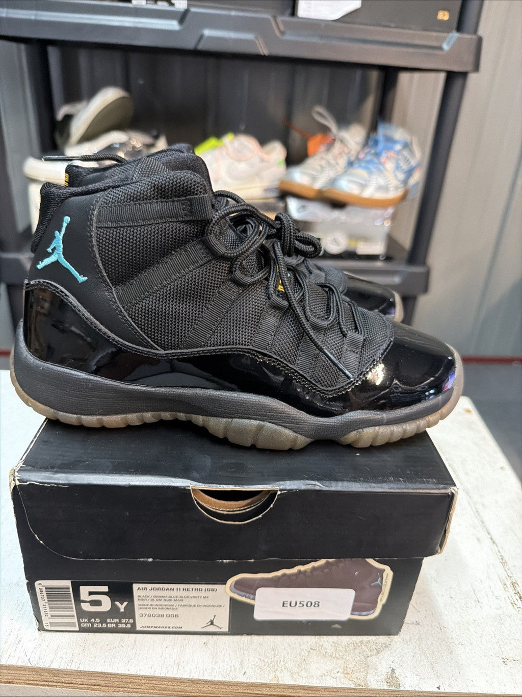 Air Jordan 11 Retro Gamma Blue Sneakers Black Patent in Leather - product image from the listing.
