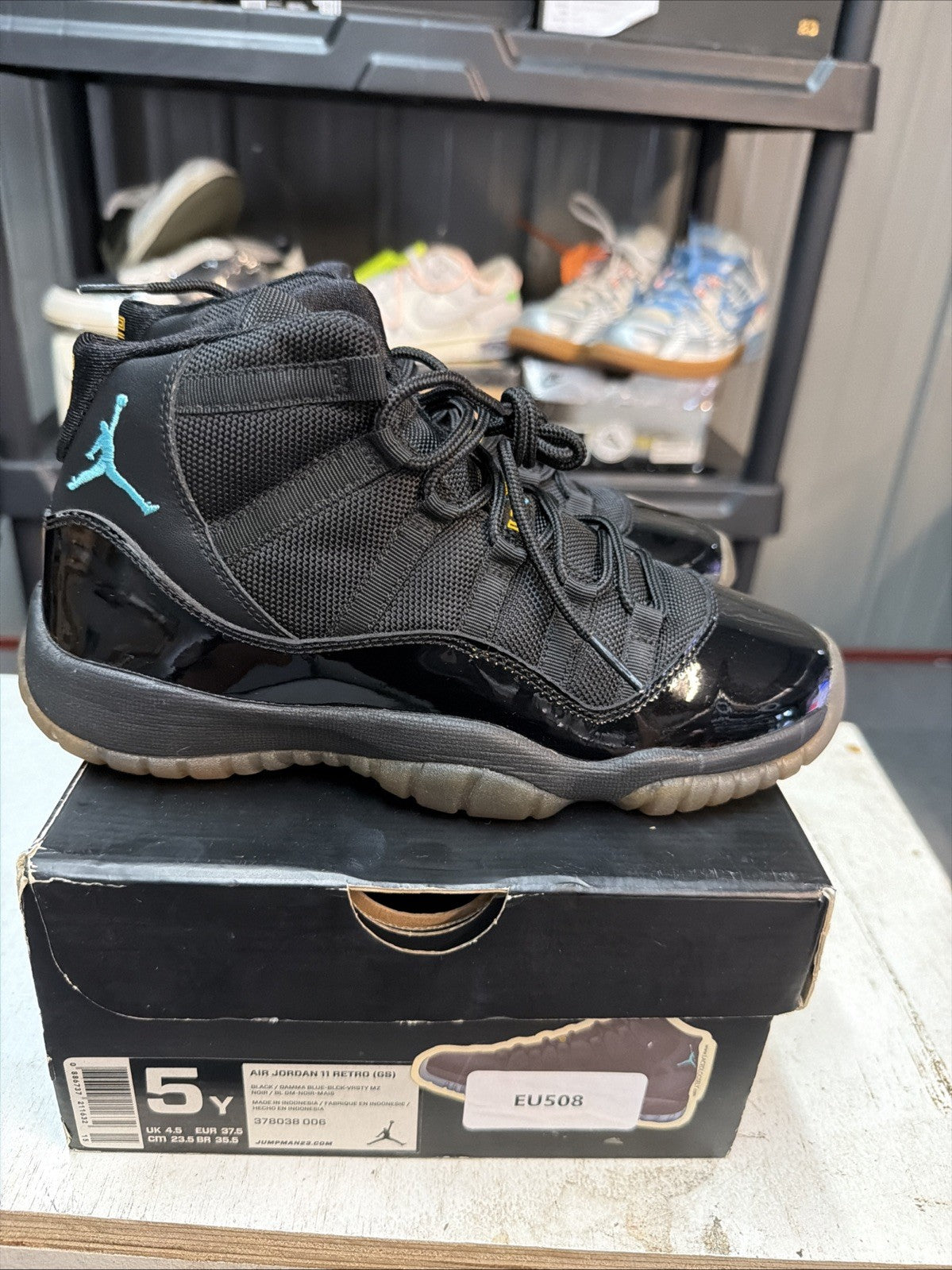 Air Jordan 11 Retro Gamma Blue Sneakers Black Patent in Leather - product image from the listing.