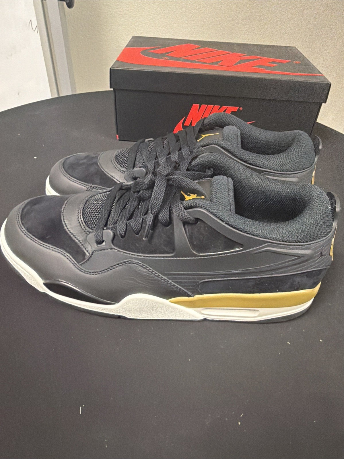 Men's Air Jordan 4 RM Shoes (Black/Sail/Team Gold/Metallic Gold) - product image from the listing.