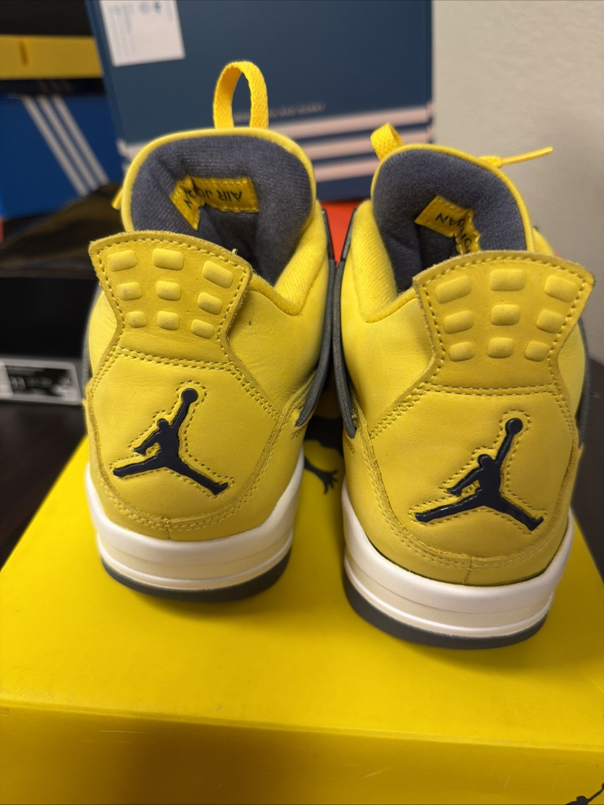 Air Jordan 4 Retro Tour Yellow/Dark in Blue Grey - product image from the listing.