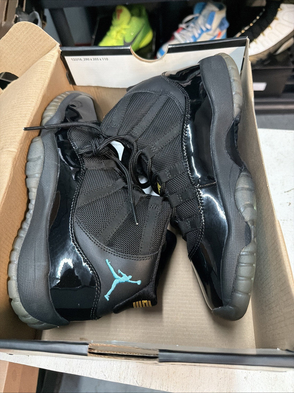 Air Jordan 11 Retro Gamma Blue Sneakers Black Patent in Leather - product image from the listing.