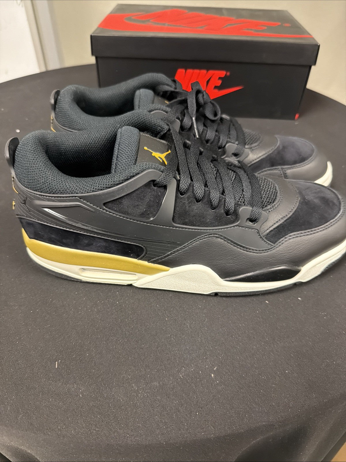 Men's Air Jordan 4 RM Shoes (Black/Sail/Team Gold/Metallic Gold) - product image from the listing.