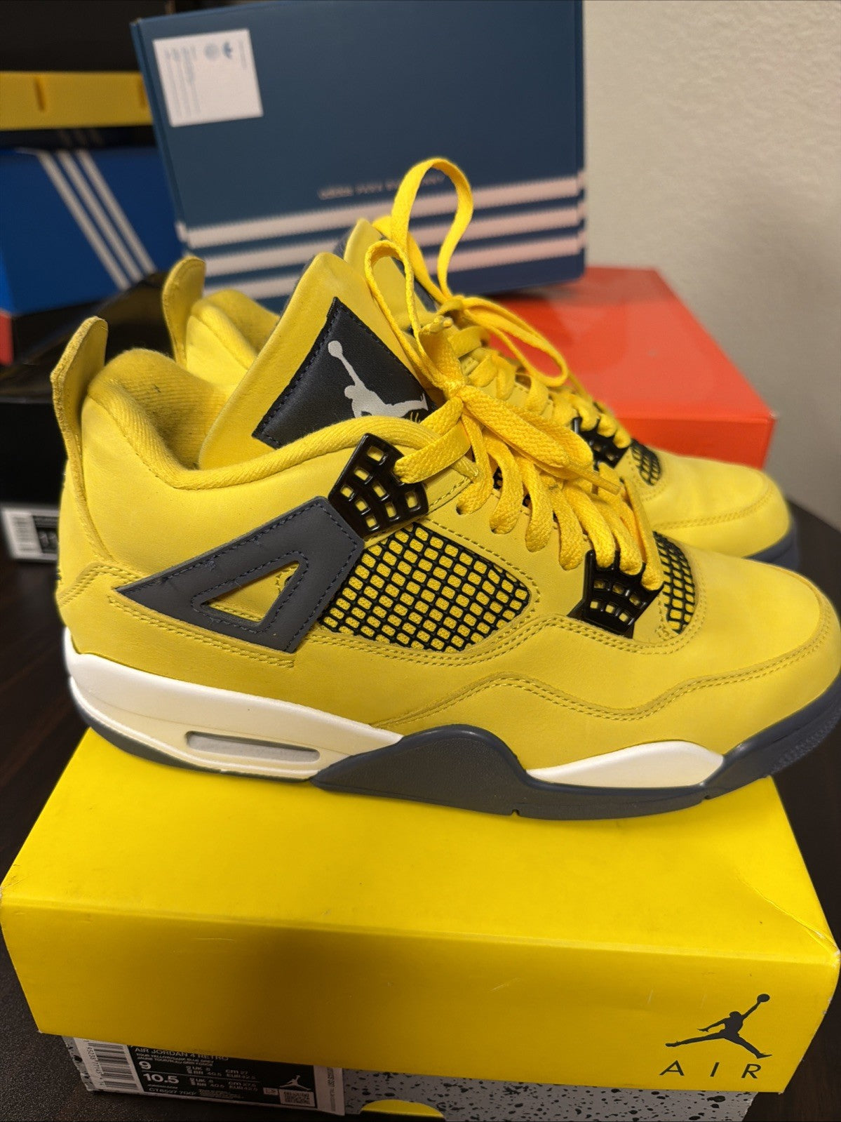 Air Jordan 4 Retro Tour Yellow/Dark in Blue Grey - product image from the listing.