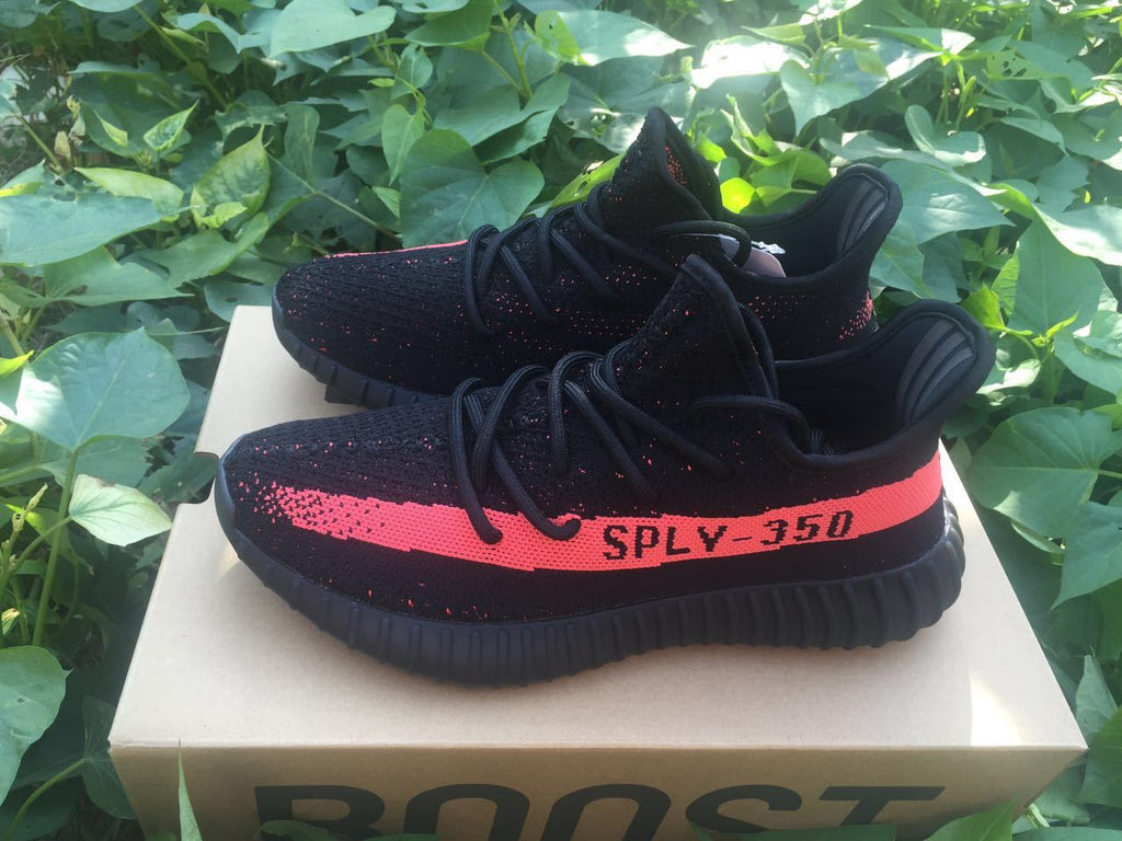 Yeezy Boost 350 V2 Sneakers in Black and Bright Coral - product image from the listing.