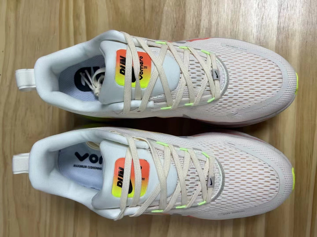 Nike Vomero 18 Running Shoes in White Volt Orange - product image from the listing.