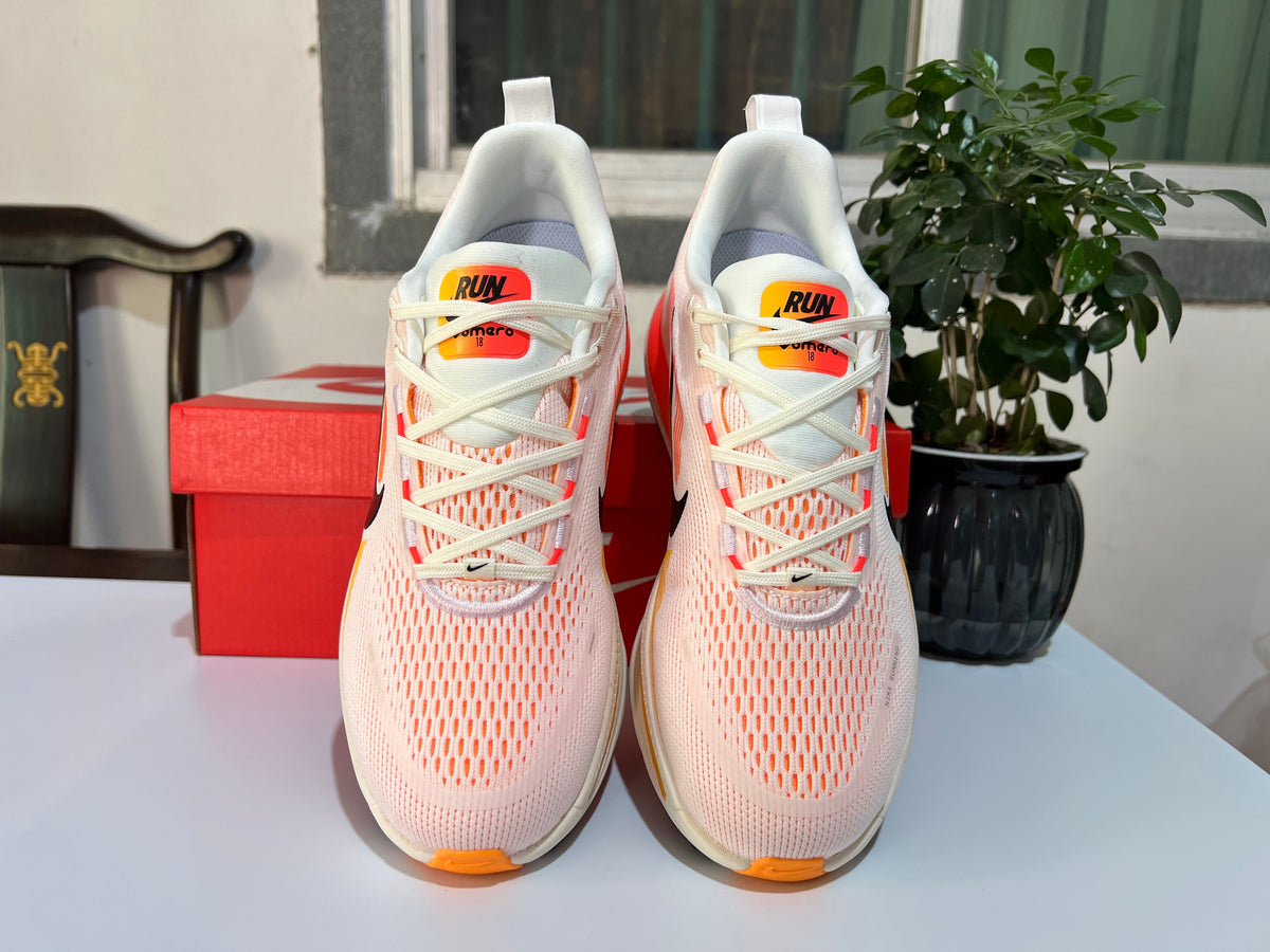 Nike Vomero 18 Running Shoes, in White and Coral - product image from the listing.
