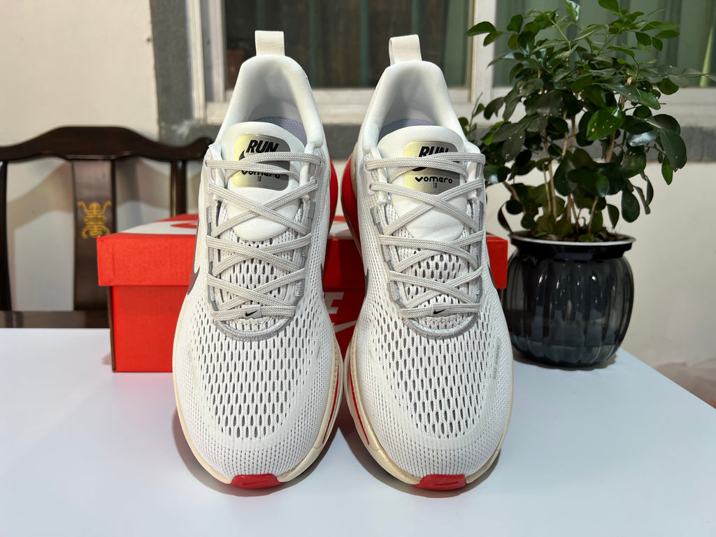 Nike Vomero 18 Running Shoes in White and Red - product image from the listing.