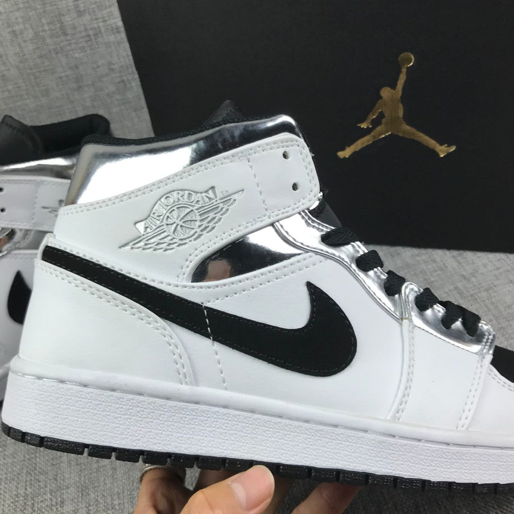 Air Jordan 1 Mid Sneakers in White and Black - product image from the listing.