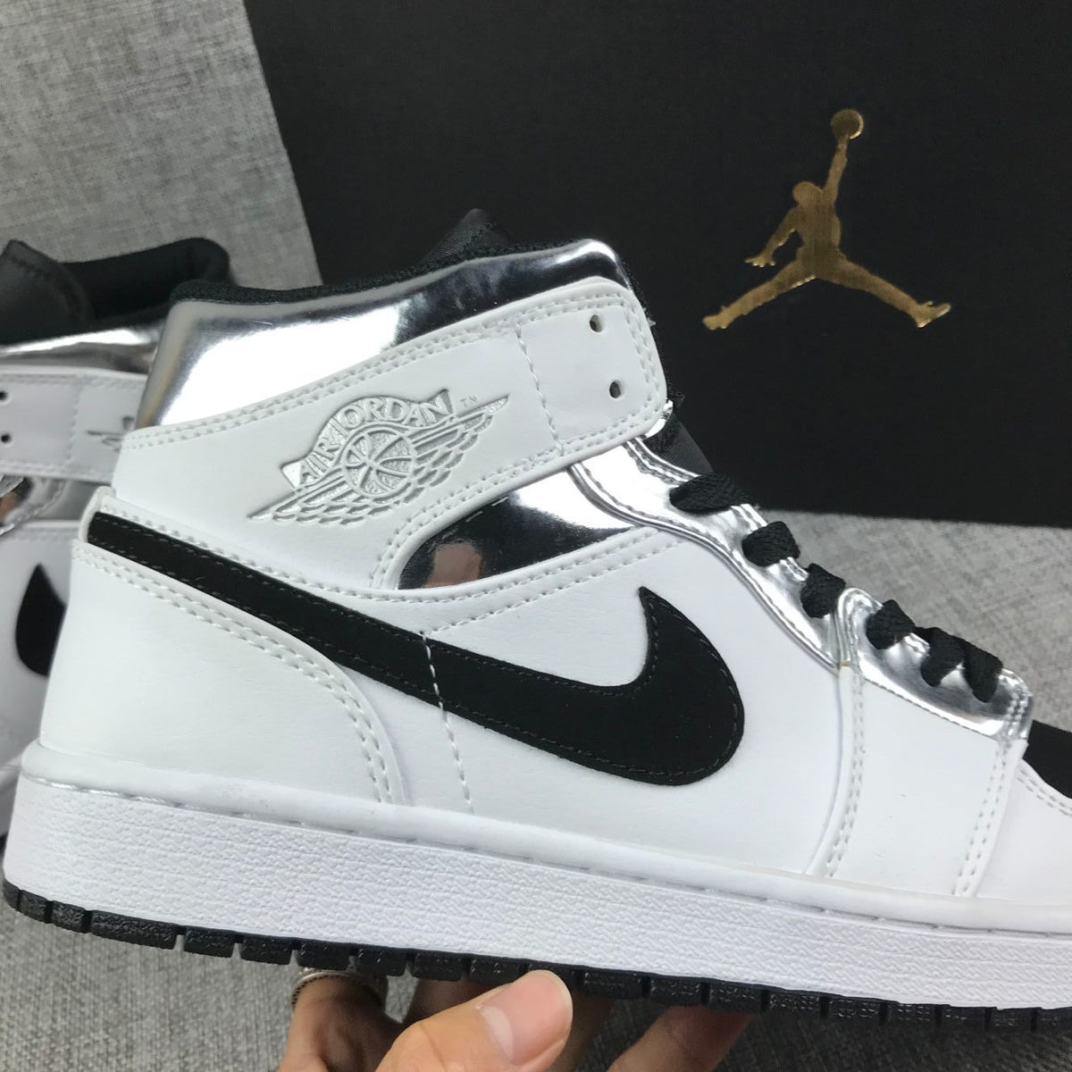 Air Jordan 1 Mid Sneakers in White and Black - product image from the listing.
