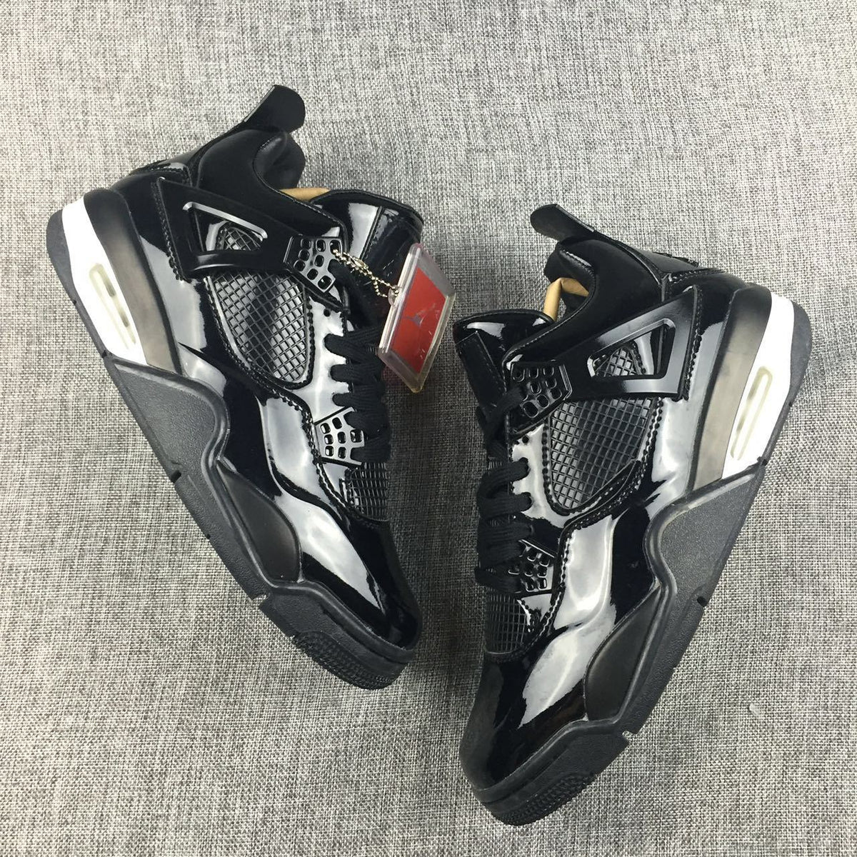 Air Jordan 4 Black Glossy Sneakers - product image from the listing.