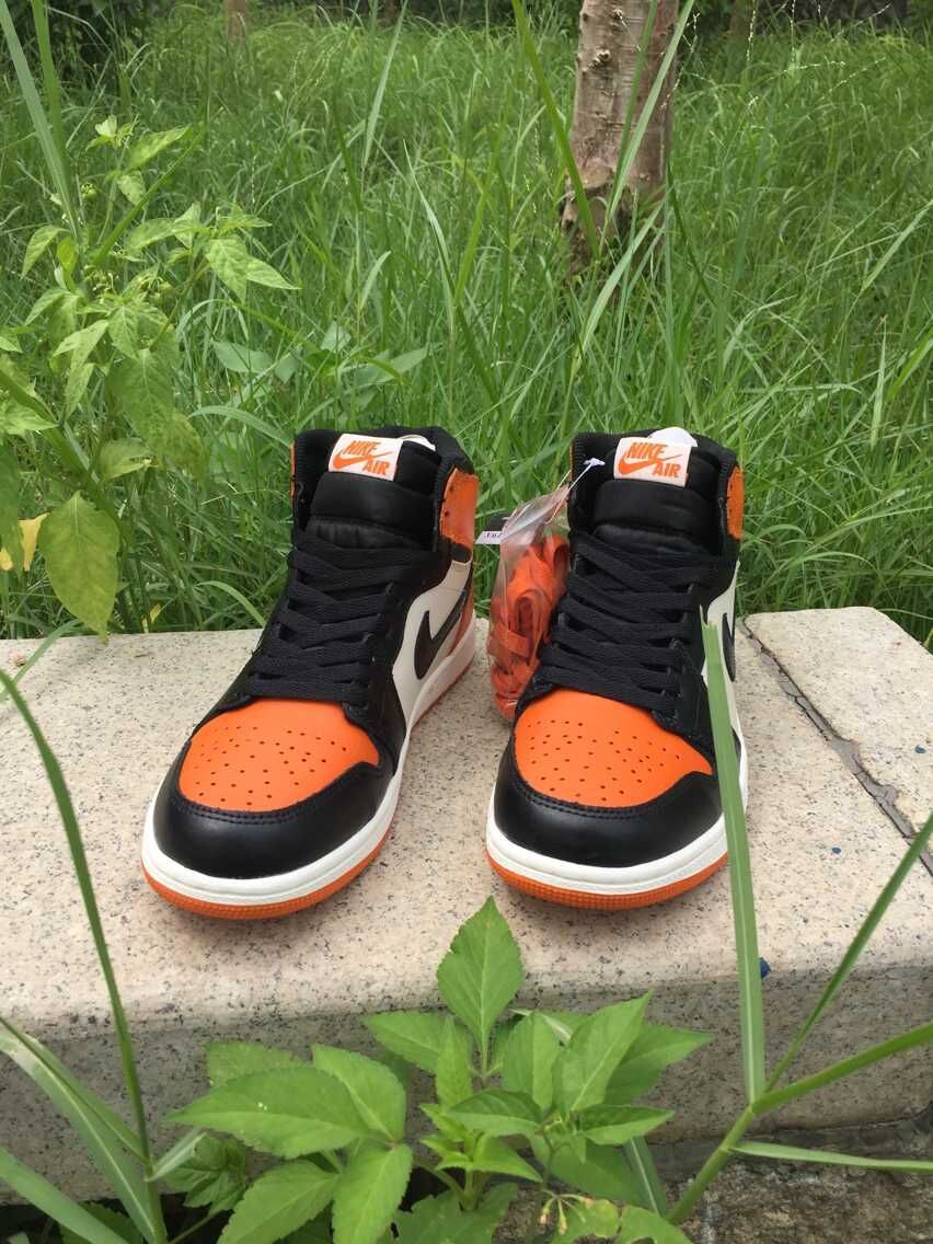 Jordan 1 High Sneakers in Black, in White and Orange - product image from the listing.