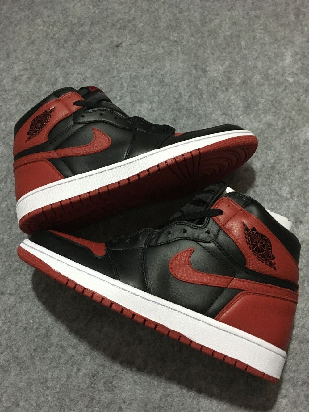 Air Jordan 1 High Sneakers in Black and Red - product image from the listing.
