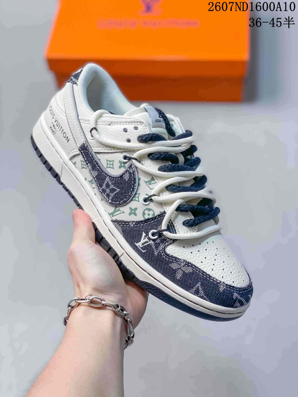 Nike SB Dunk Low Low-Top Sneakers in White and Navy - product image from the listing.
