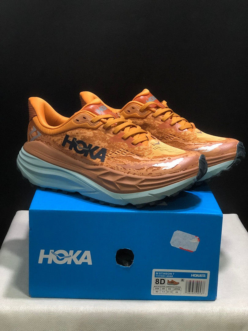Orange HOKA Stinson 7 Trail Running Shoes - product image from the listing.