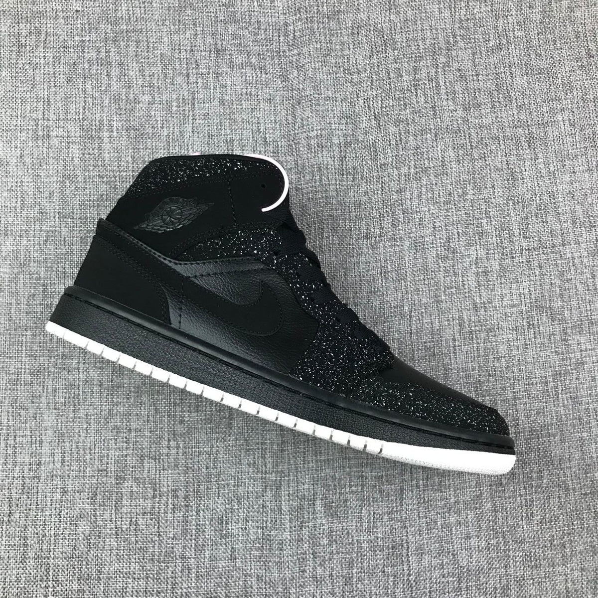 Air Jordan 1 Mid Black and White Sneakers 554724-001 - product image from the listing.