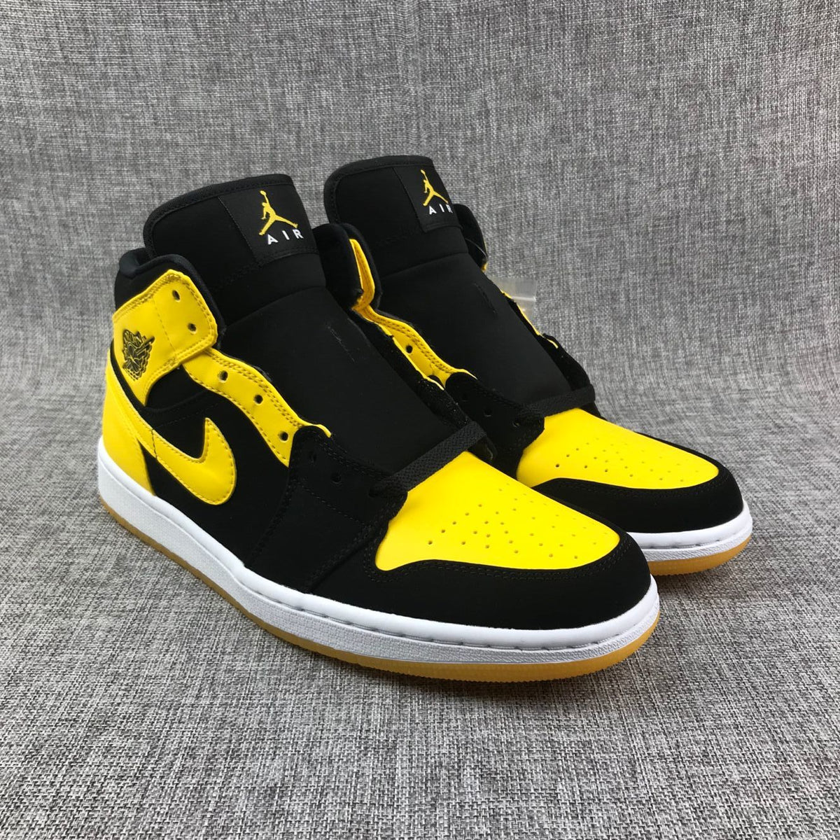 Air Jordan 1 Mid Sneakers in Black and Yellow - product image from the listing.