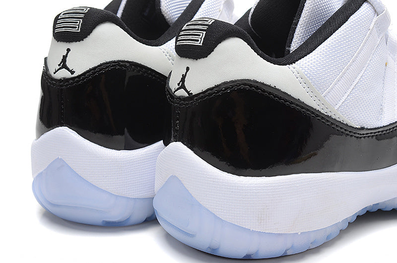 Air Jordan 11 Low Basketball Sneakers in White Black - product image from the listing.
