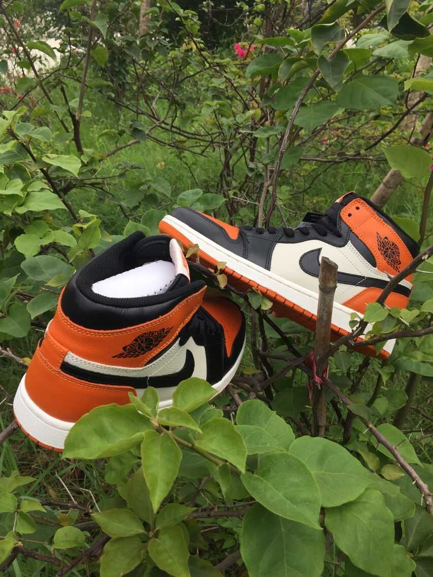 Jordan 1 High Sneakers in Black, in White and Orange - product image from the listing.