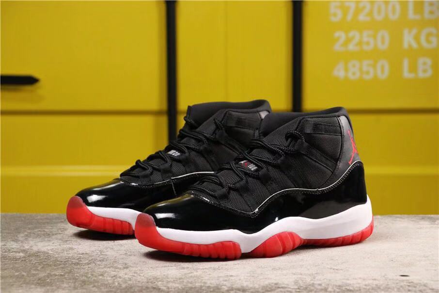 Air Jordan 11 Retro Bred High-Top Sneakers in Black and Red - product image from the listing.