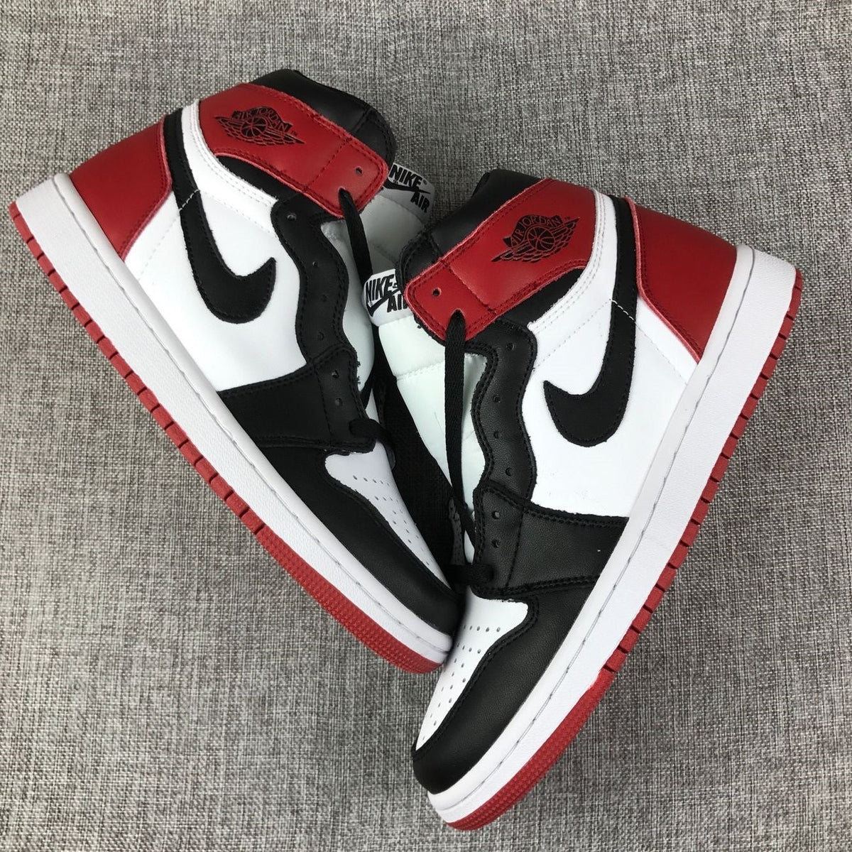 Black Toe Sneakers - Air Jordan 1 High 555088-184 - product image from the listing.