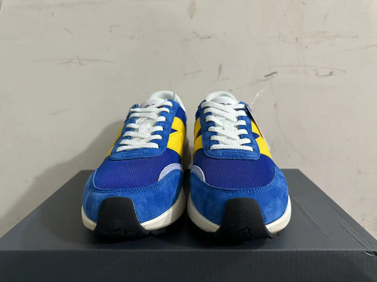 New Balance U370 Sneakers in Blue and Yellow - product image from the listing.