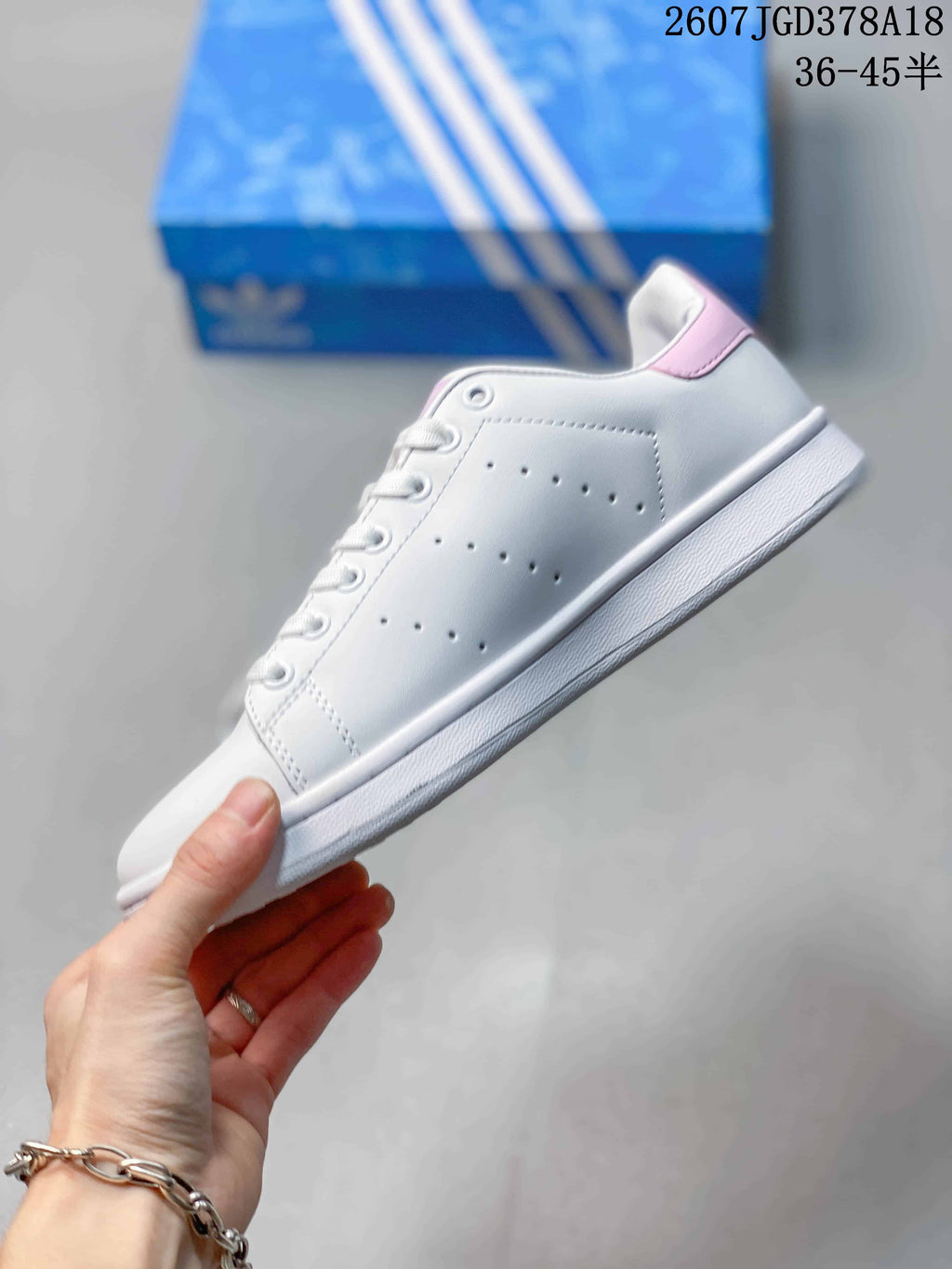 adidas Stan Smith Low-Top Sneakers in White and Pink - product image from the listing.