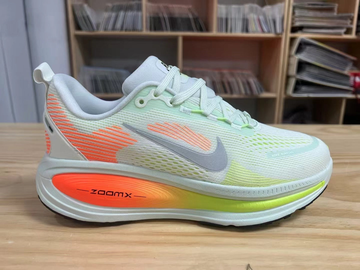 Nike Vomero 18 Running Shoes in Light Blue and Volt - product image from the listing.
