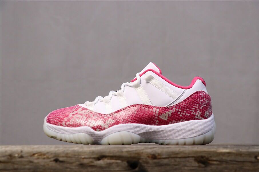 Women's Air Jordan 11 Retro Low Pink Snakeskin Sneakers - product image from the listing.
