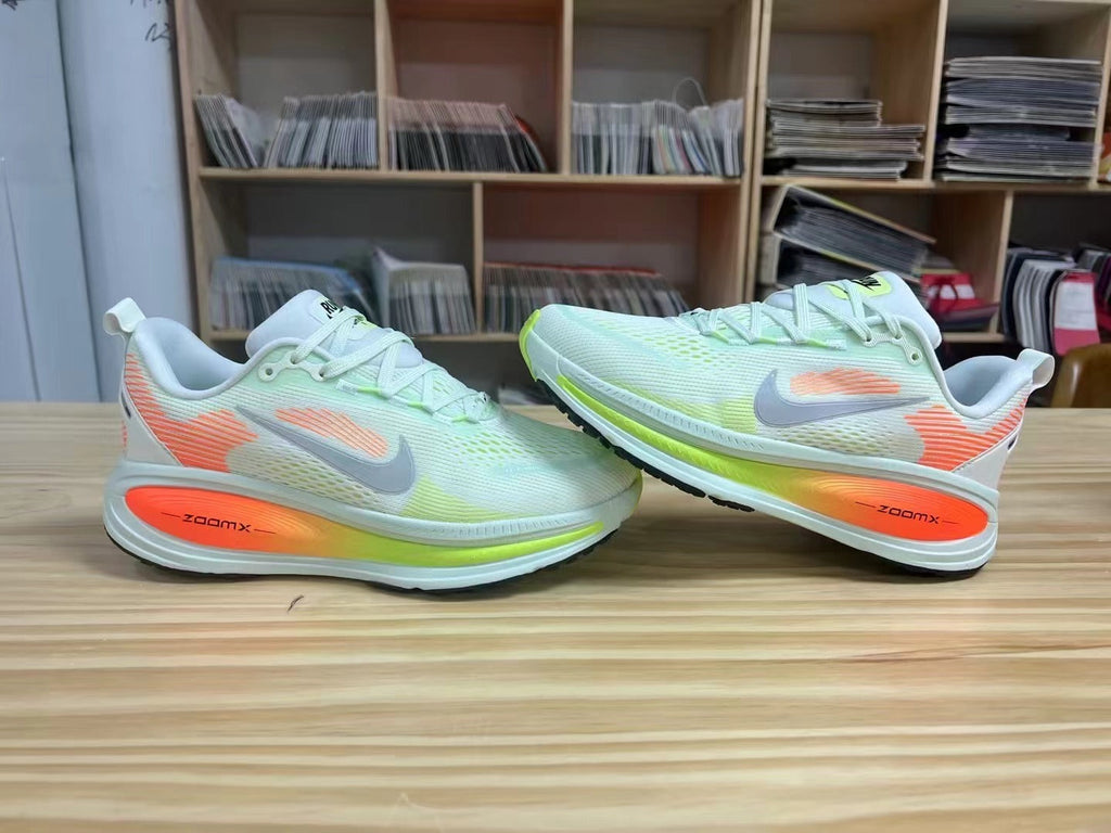 Nike Vomero 18 Running Shoes in Light Blue and Volt - product image from the listing.