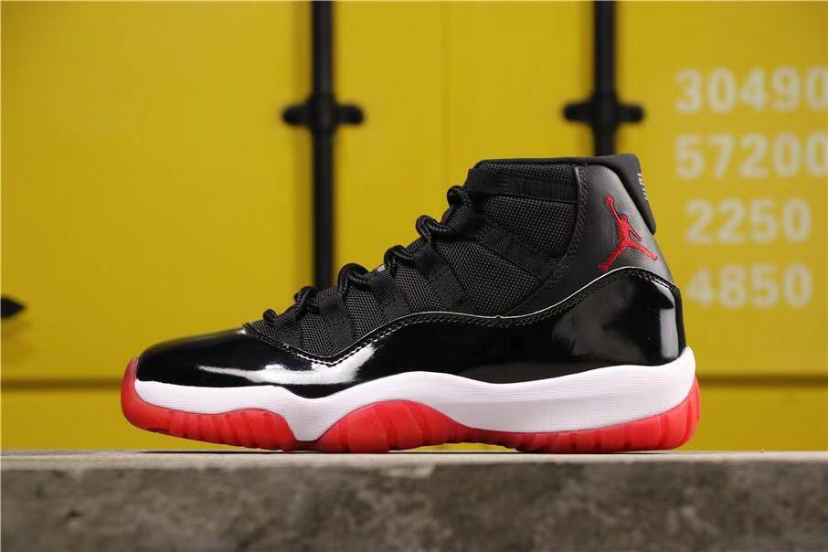 Air Jordan 11 Retro Bred High-Top Sneakers in Black and Red - product image from the listing.