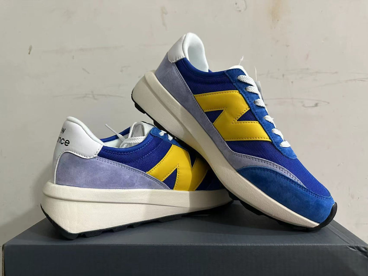 New Balance U370 Sneakers in Blue and Yellow - product image from the listing.