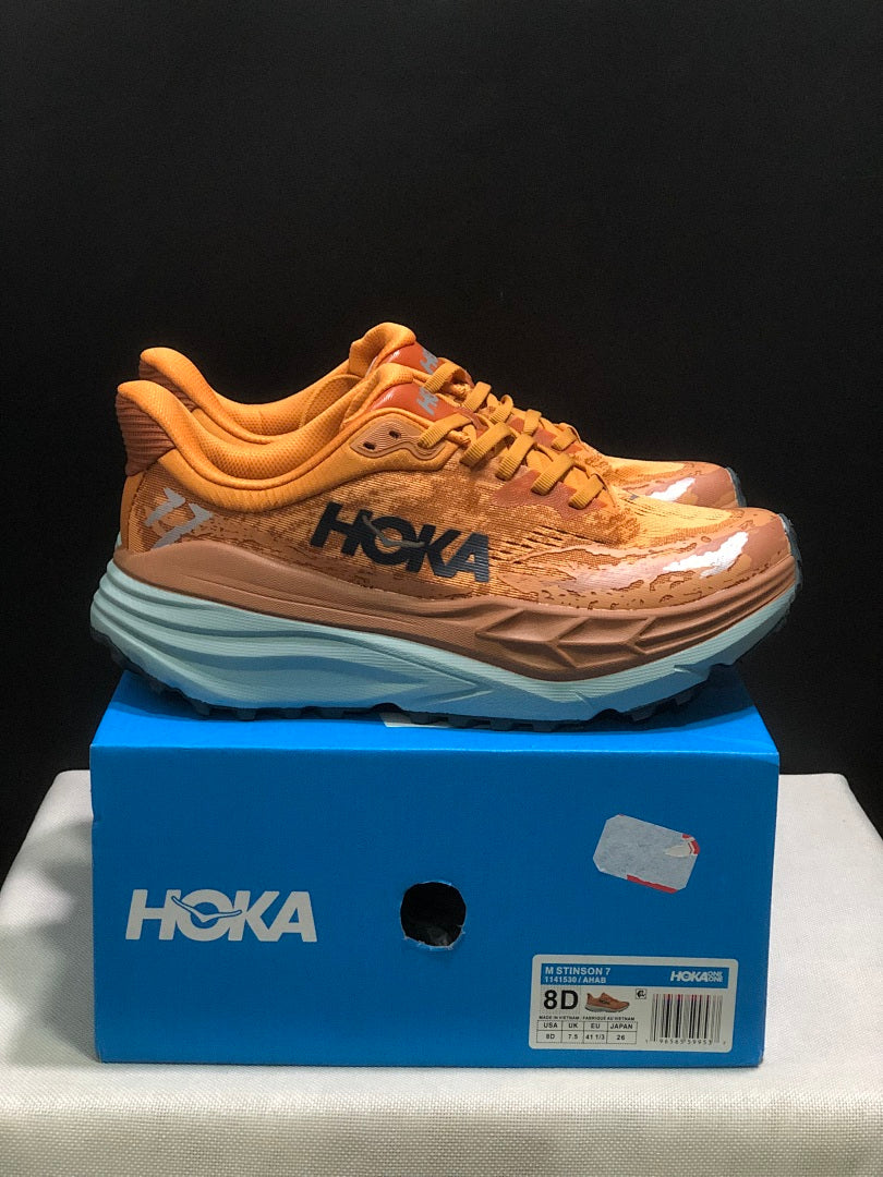 Orange HOKA Stinson 7 Trail Running Shoes - product image from the listing.