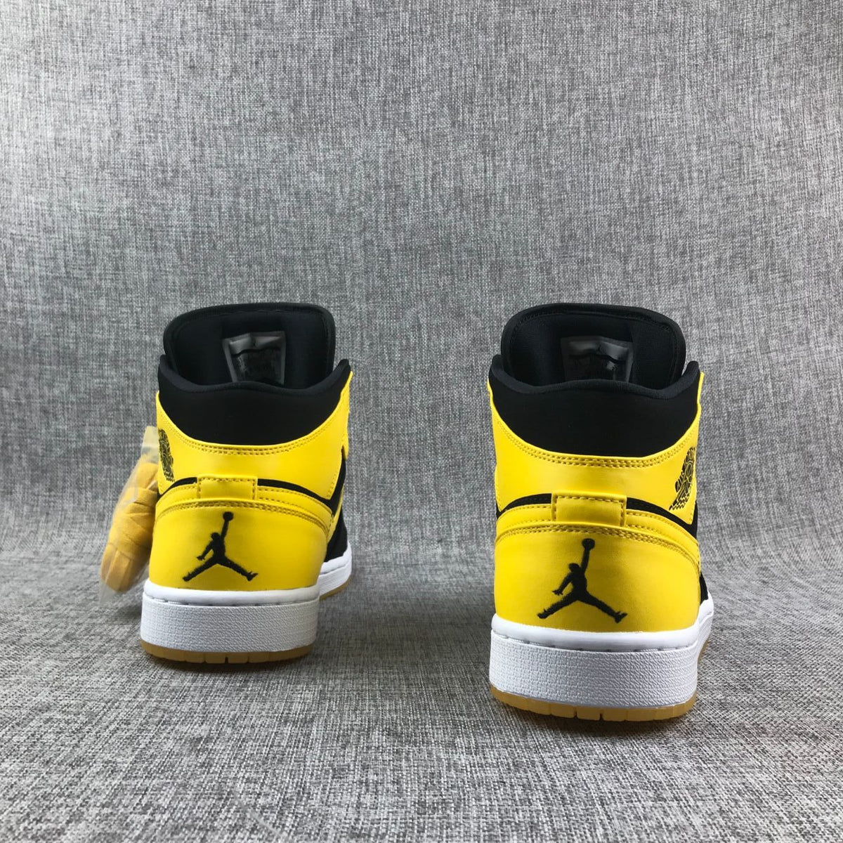 Air Jordan 1 Mid Sneakers in Black and Yellow - product image from the listing.