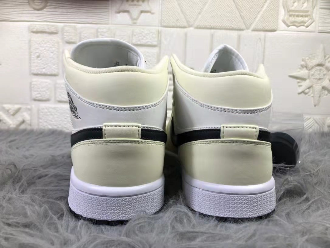 Jordan Air 1 Mid Sneakers in Cream White and Black - product image from the listing.