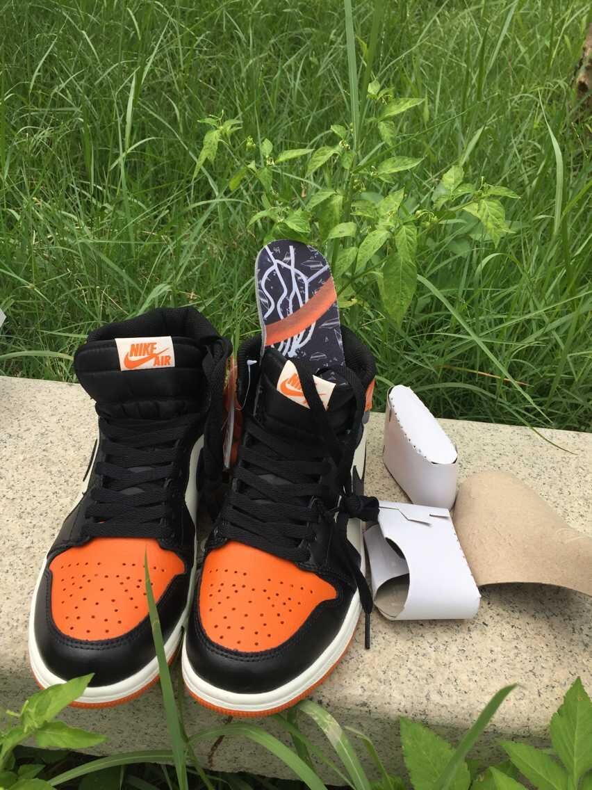 Jordan 1 High Sneakers in Black, in White and Orange - product image from the listing.