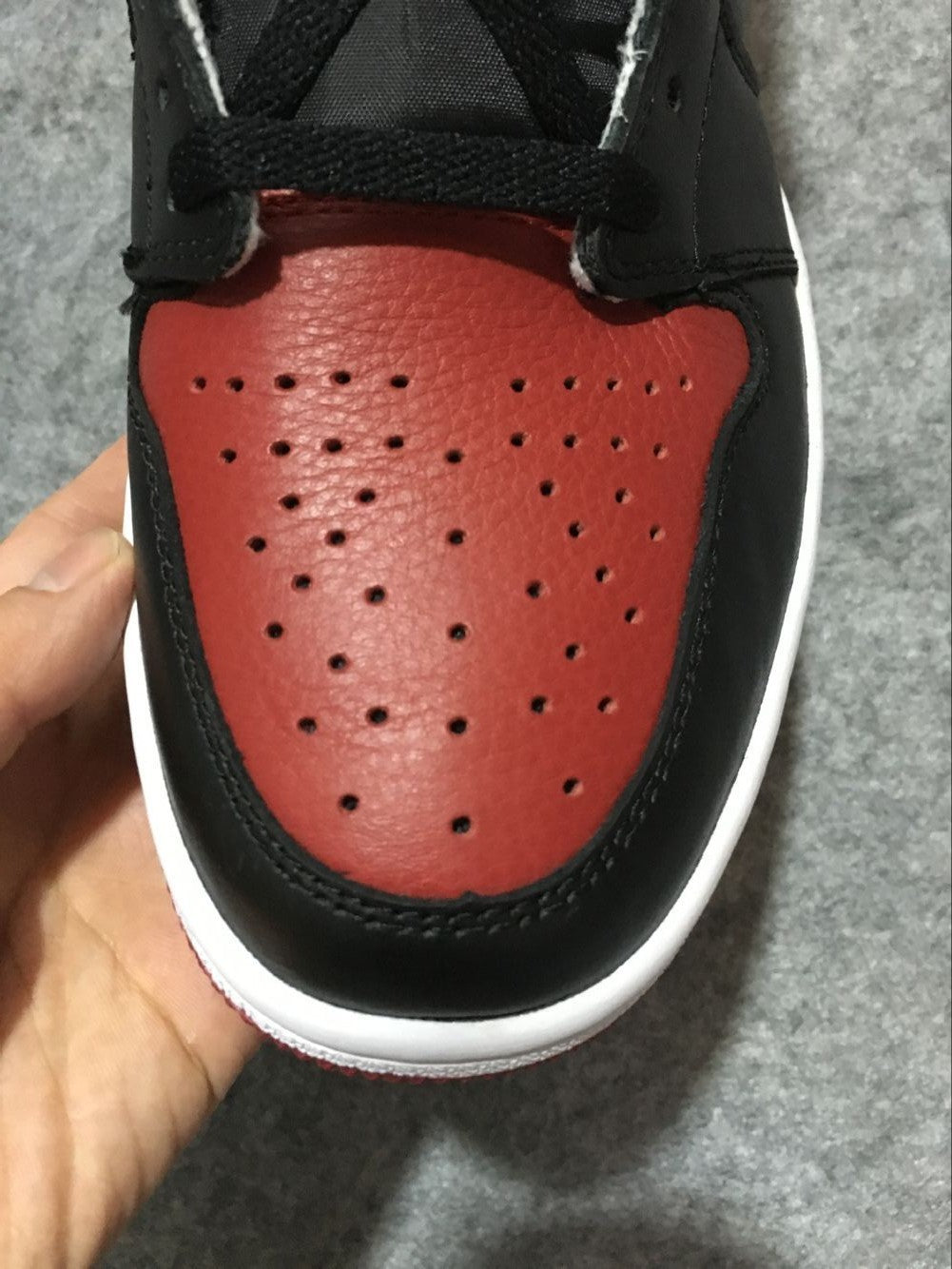 Air Jordan 1 High Sneakers in Black and Red - product image from the listing.