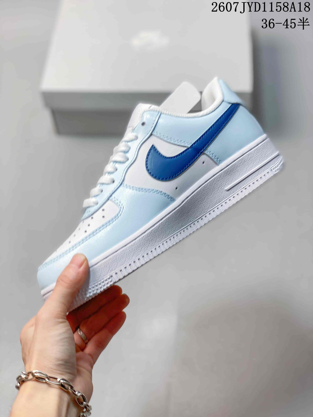 Nike Air Force 1 '07 Low Sneakers, in White and Light Blue - product image from the listing.