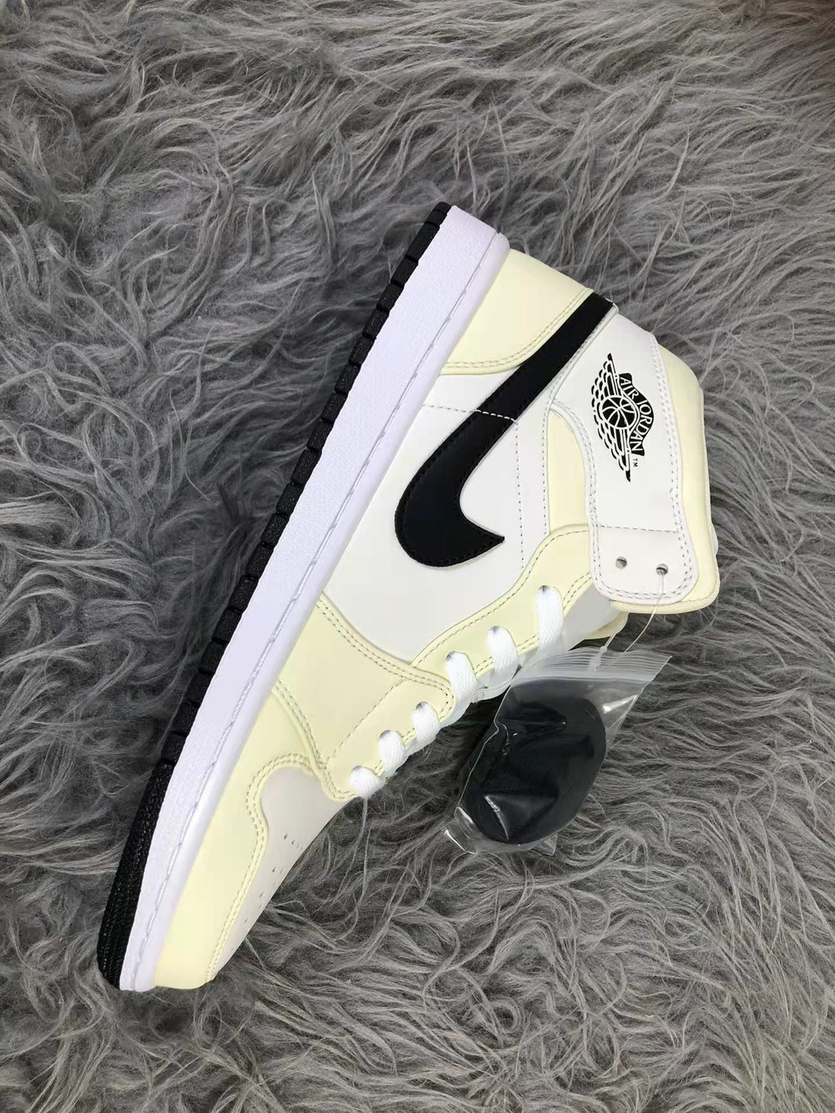 Jordan Air 1 Mid Sneakers in Cream White and Black - product image from the listing.