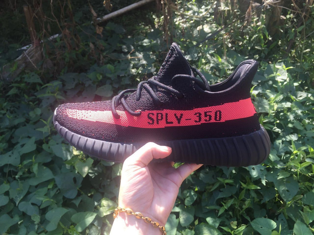 Yeezy Boost 350 V2 Sneakers in Black and Bright Coral - product image from the listing.