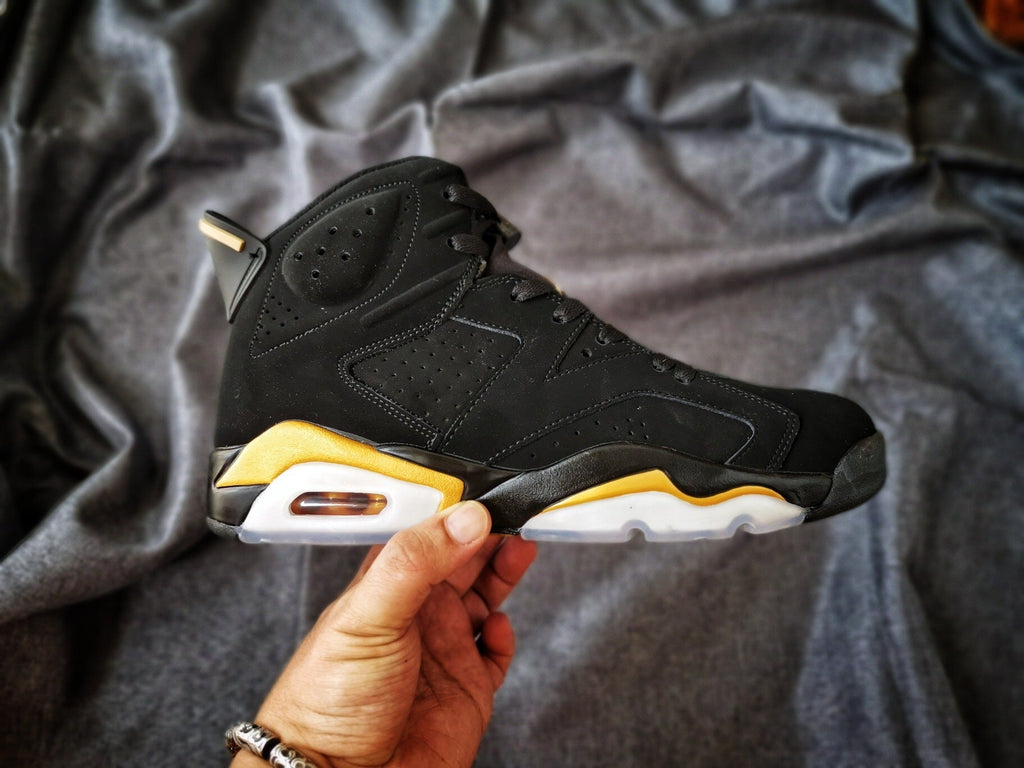 Air Jordan 6 High-Top Sneakers in Black and Gold - product image from the listing.
