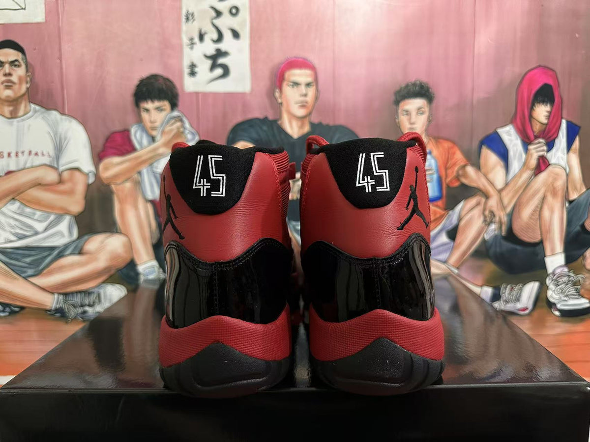 Jordan 11 High-Top Sneakers in Black and Red - product image from the listing.