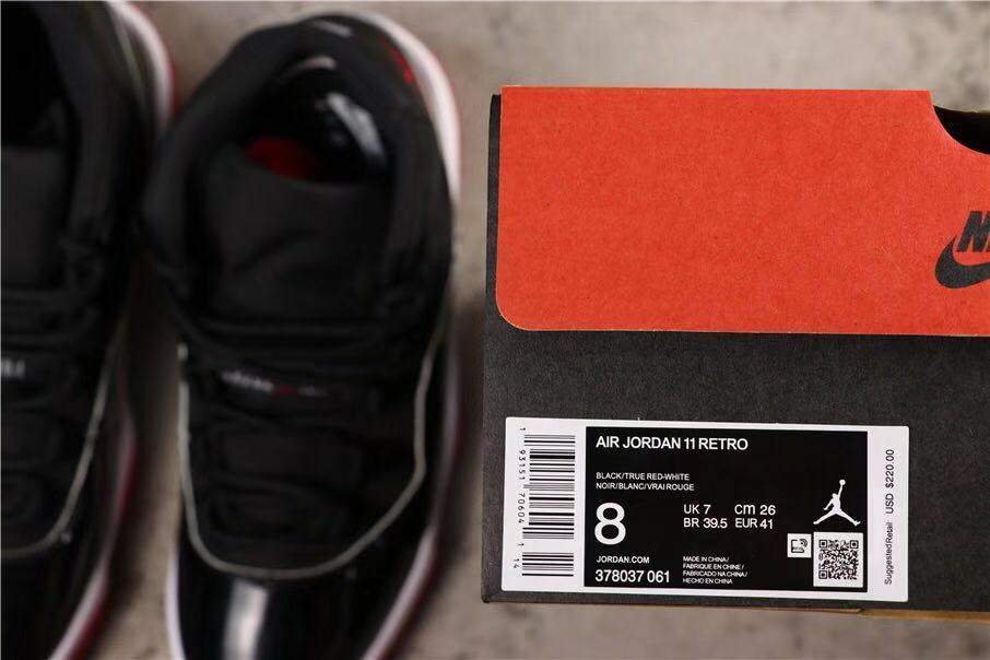 Air Jordan 11 Retro Bred High-Top Sneakers in Black and Red - product image from the listing.