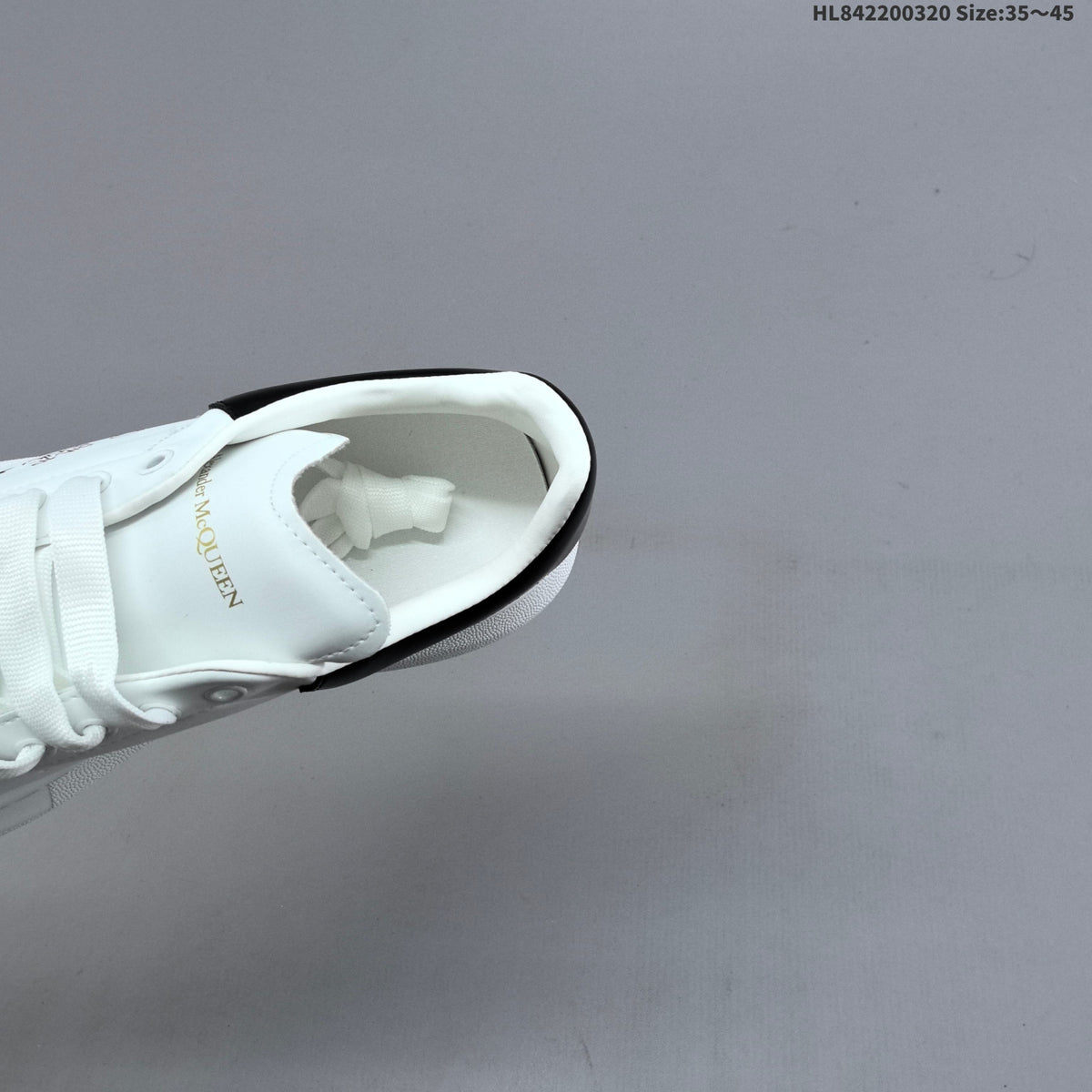 Alexander McQueen Oversized Low-Top Sneakers, in White and Black - product image from the listing.