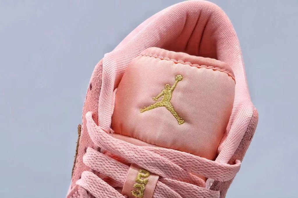 Women's Jordan 1 Low Pink and Gold Sneakers - product image from the listing.