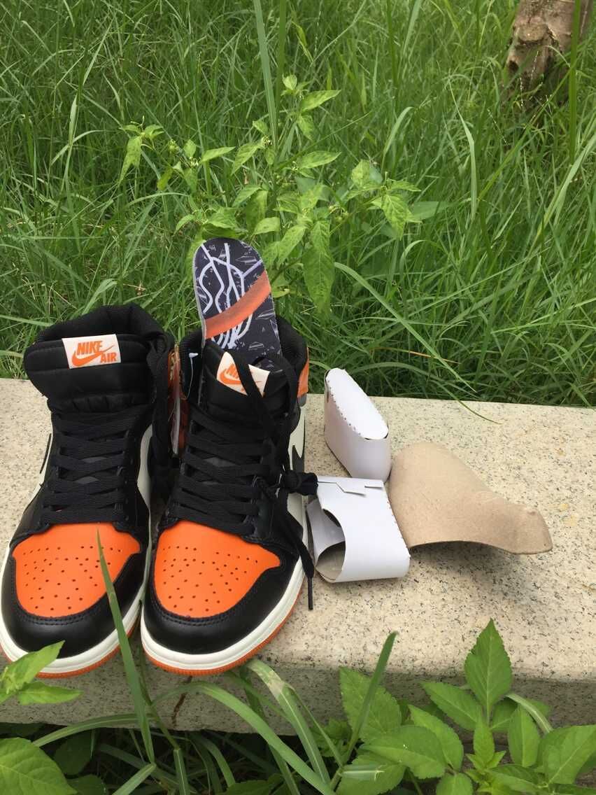Jordan 1 High Sneakers in Black, in White and Orange - product image from the listing.