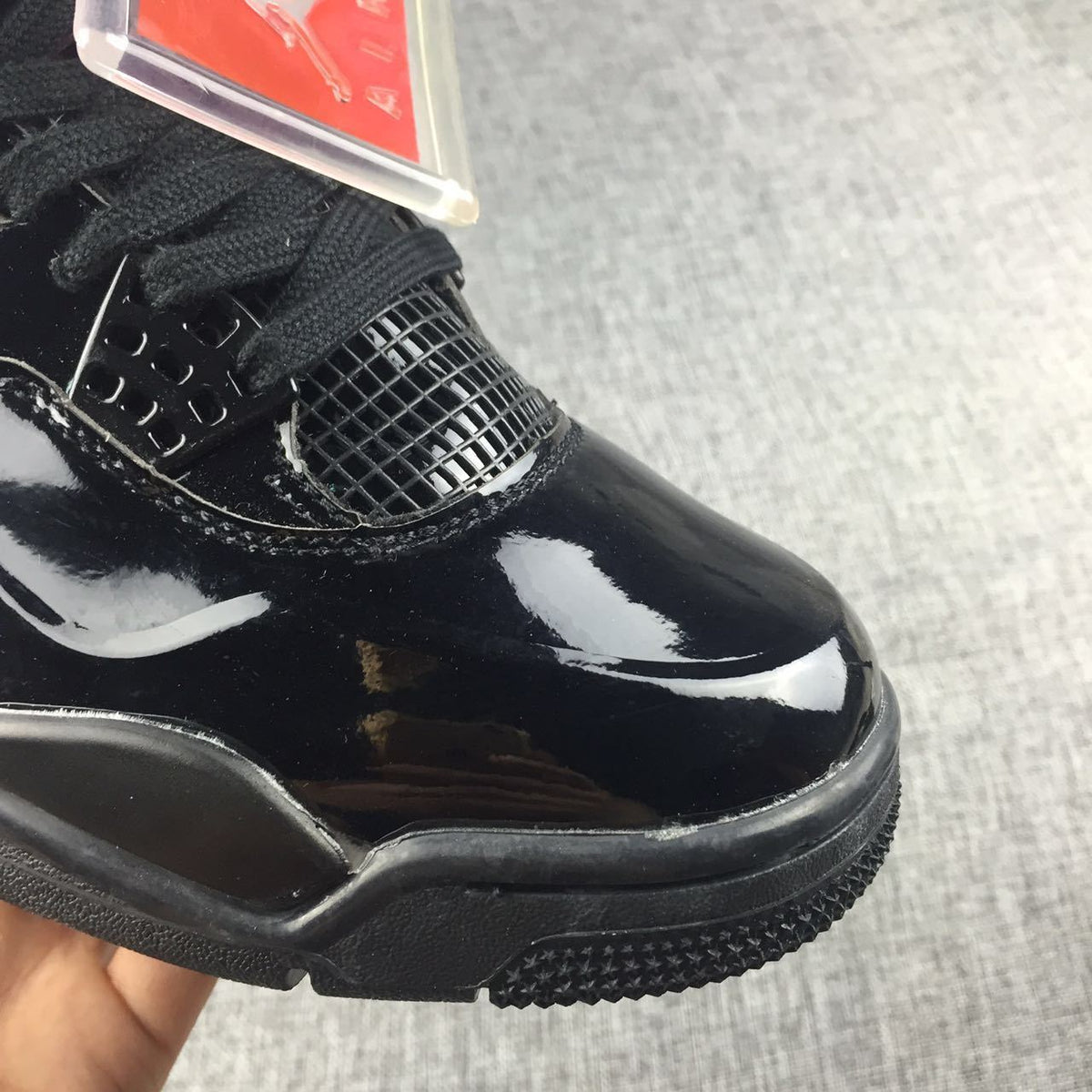 Air Jordan 4 Black Glossy Sneakers - product image from the listing.