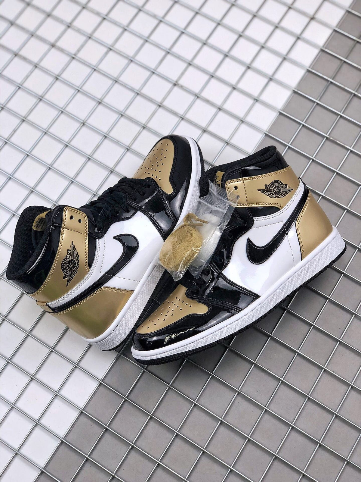 Air Jordan 1 High Gold Toe Sneakers in Black and Gold - product image from the listing.