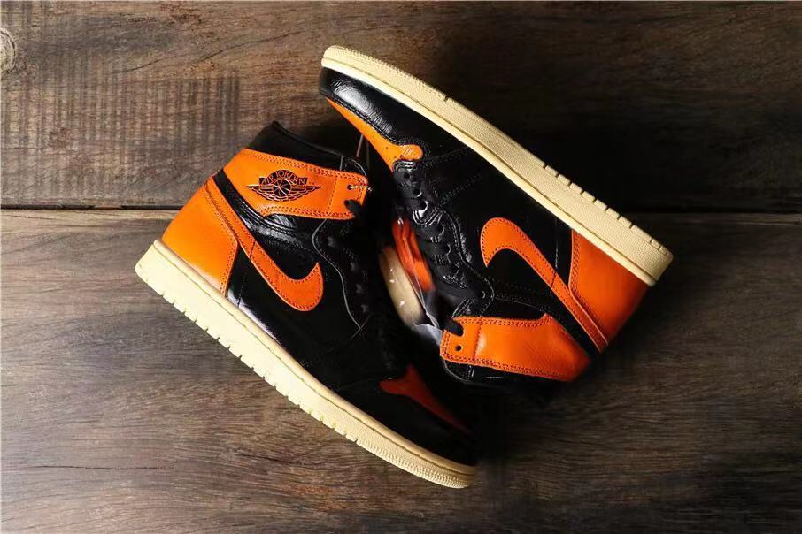 Air Jordan 1 Retro High OG Sneakers in Black and Orange - product image from the listing.