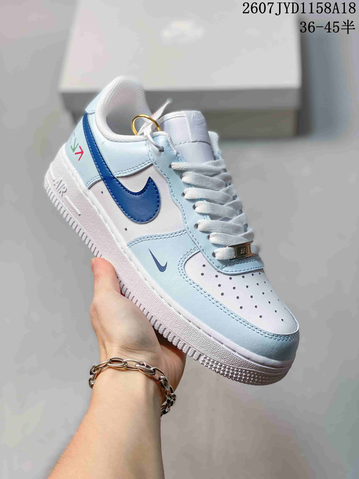 Nike Air Force 1 '07 Low Sneakers, in White and Light Blue - product image from the listing.